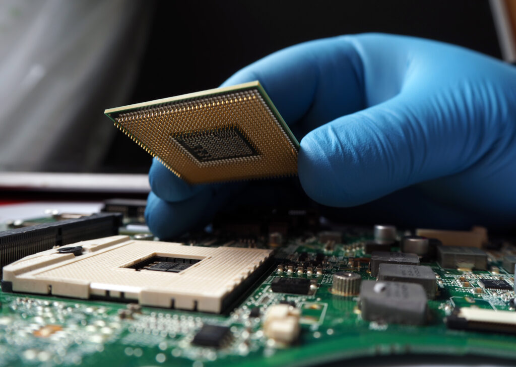 Technician plug in microprocessor to socket
